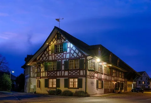 Die Taverne zum Schäfli zur blauen Stunde mit Licht in den Fenstern